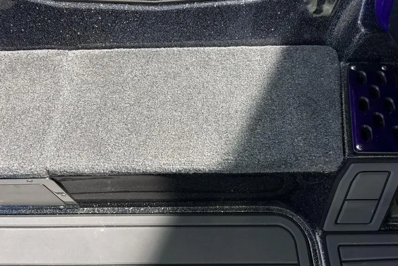 Slide: The Image of Interior of 2026 Phoenix 920 Elite X with gray carpeted surface and storage compartments. - 17