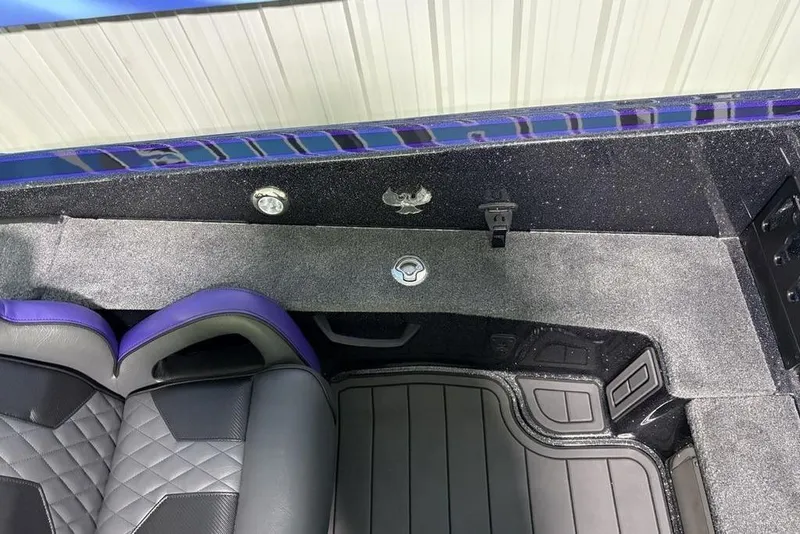 Slide: The Image of Interior of 2026 Phoenix 920 Elite X boat with black and purple seating. - 18