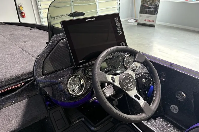 Slide: The Image of Steering console of 2026 Phoenix 920 Elite X boat with advanced navigation display. - 23