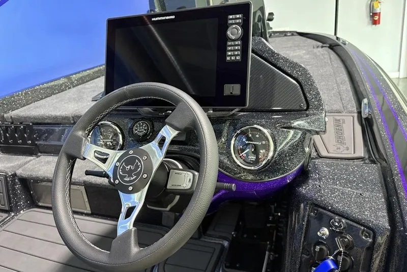 Slide: The Image of 2026 Phoenix 920 Elite X boat dashboard with steering wheel and digital display. - 25