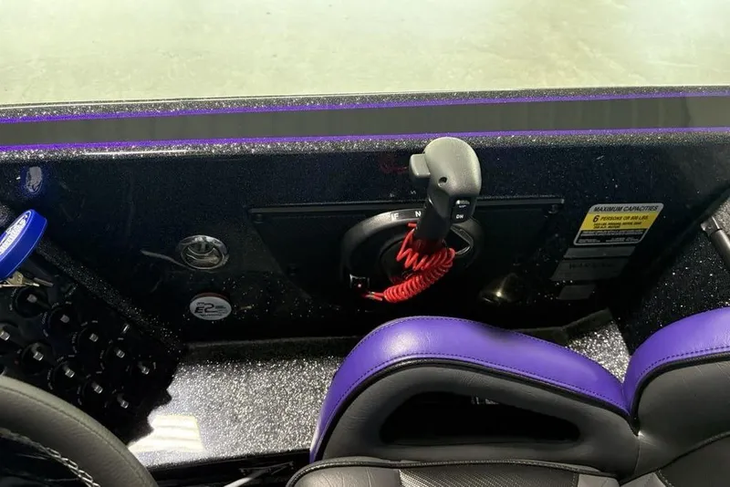 Slide: The Image of Interior of 2026 Phoenix 920 Elite X boat with control panel and purple accents. - 29