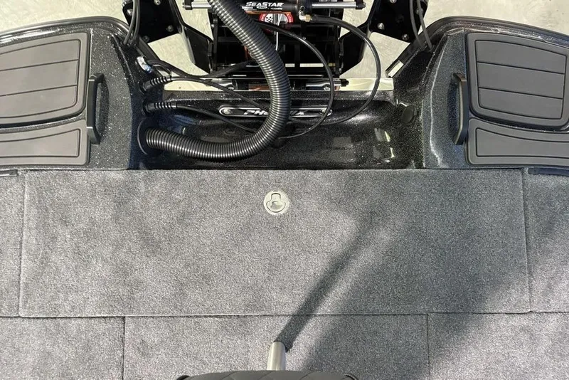 Slide: The Image of Rear deck of 2026 Phoenix 920 Elite X boat with carpeted surface and storage compartments. - 30