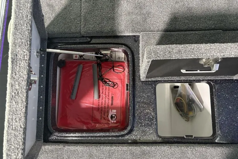 Slide: The Image of Interior compartments of a 2026 Phoenix 920 Elite X boat, featuring storage and equipment. - 32