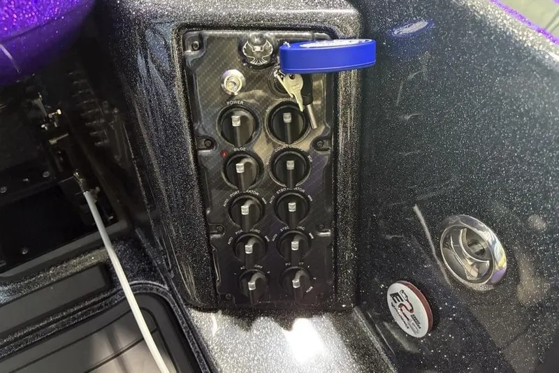 Slide: The Image of Control panel of 2026 Phoenix 920 Elite X boat with switches and key. - 33