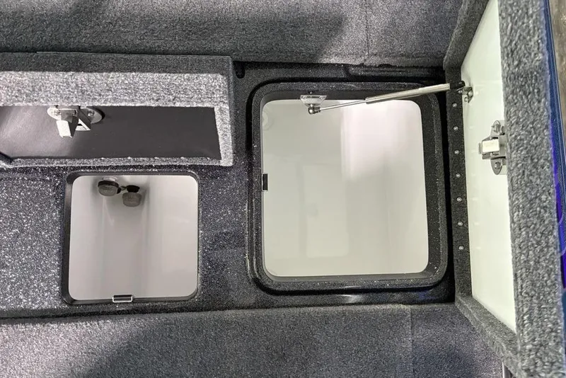 Slide: The Image of Open storage compartments in a 2026 Phoenix 920 Elite X boat interior. - 34