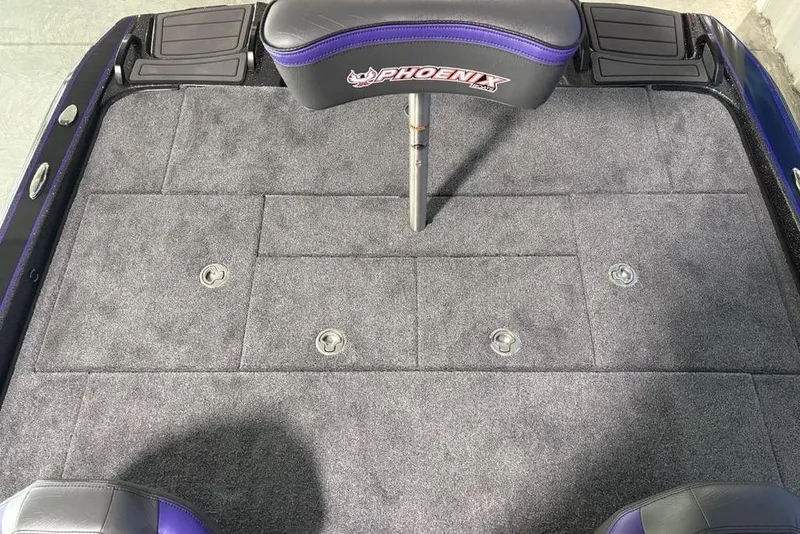 Slide: The Image of Phoenix 920 Elite X 2026 boat deck with gray carpet and branded seat. - 35