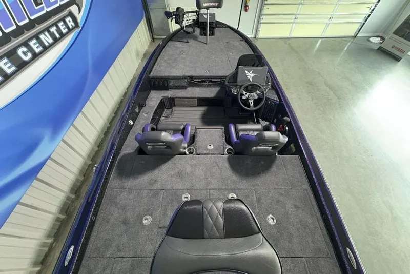 Slide: The Image of 2026 Phoenix 920 Elite X boat interior with dual seats and steering wheel in showroom. - 37