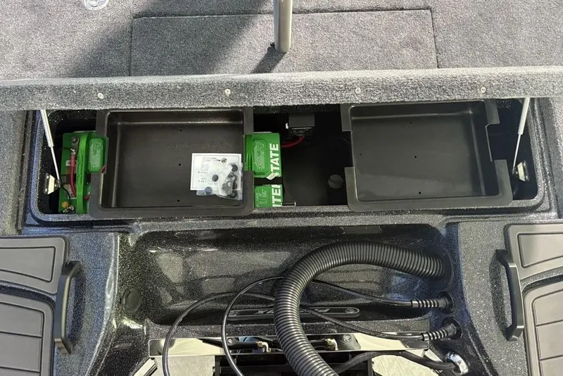 Slide: The Image of 2026 Phoenix 920 Elite X boat battery compartment with storage trays and wiring. - 38