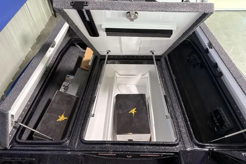 Slide: The Image of Open storage compartments in a 2026 Phoenix 920 Elite X boat, showcasing organized interior space. - 7