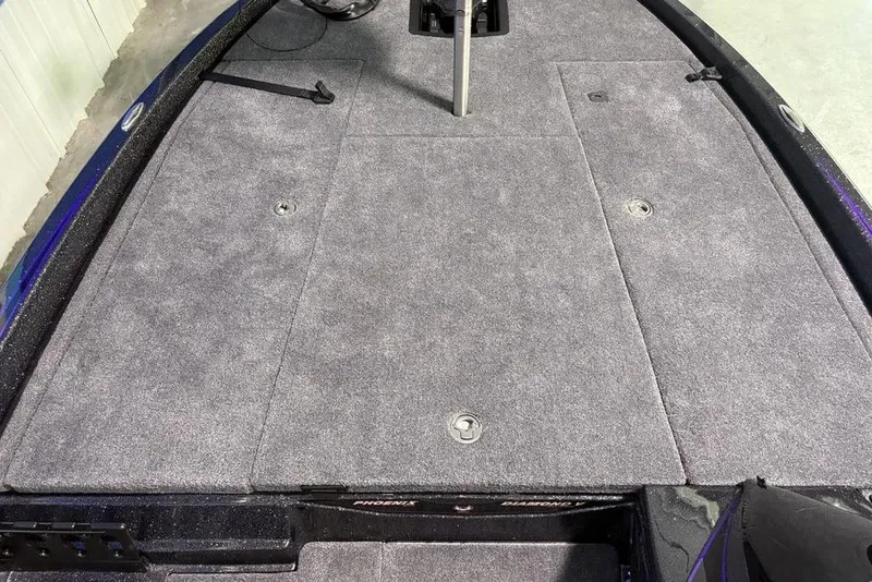 Slide: The Image of 2026 Phoenix 920 Elite X boat deck with gray carpet and storage compartments. - 9