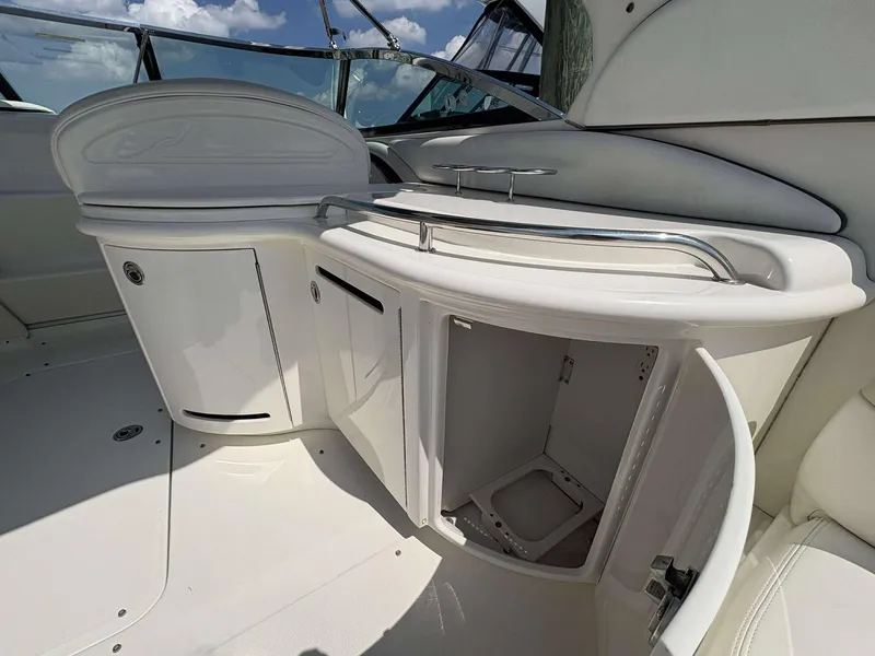 Slide: The Image of 2008 Sea Ray 290 SLX boat interior with open storage compartments under a sunny sky. - 10