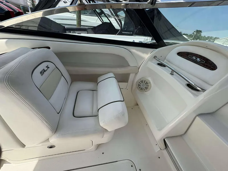 Slide: The Image of 2008 Sea Ray 290 SLX boat interior with white seating and dashboard details. - 11