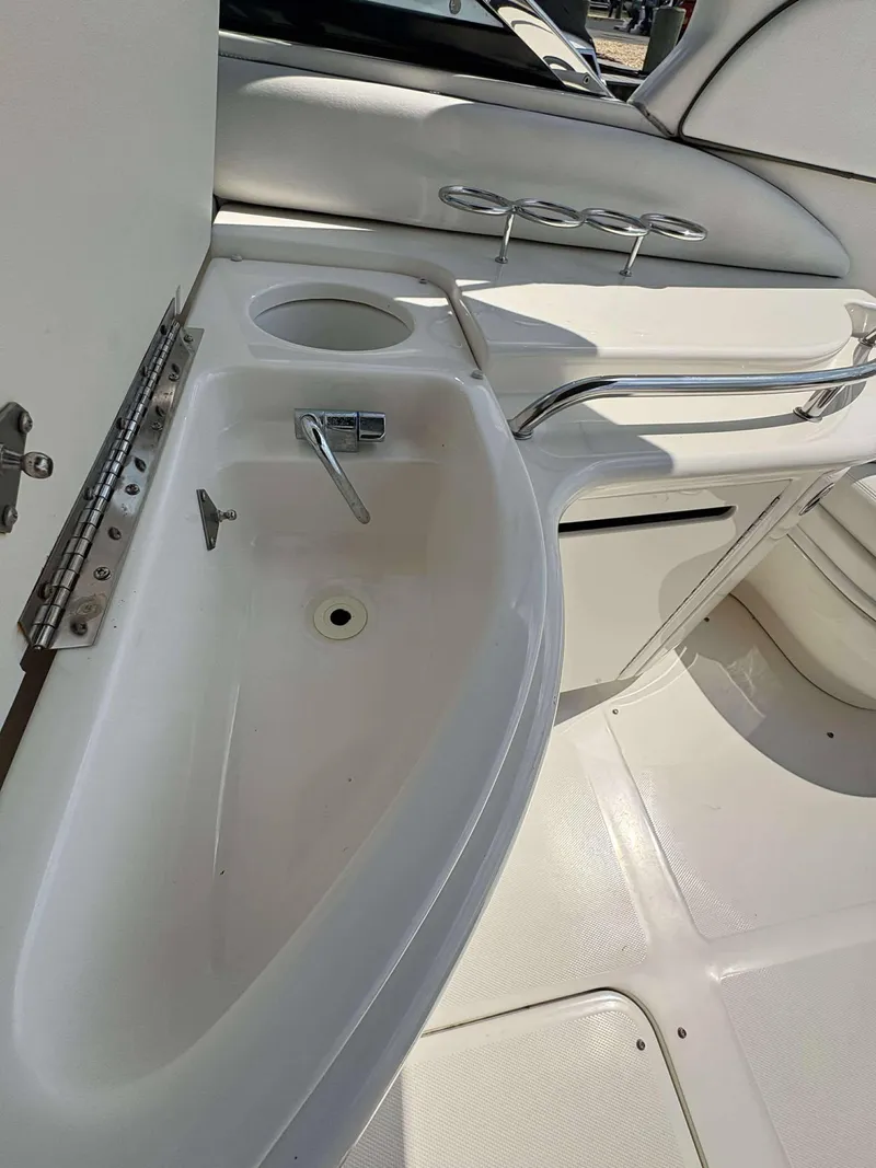 Slide: The Image of 2008 Sea Ray 290 SLX boat interior with sink and seating area. - 16