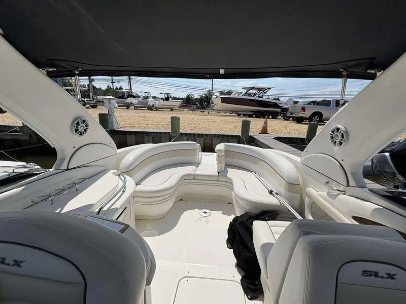 Slide: The Image of 2008 Sea Ray 290 SLX boat interior with white seating and canopy. - 17