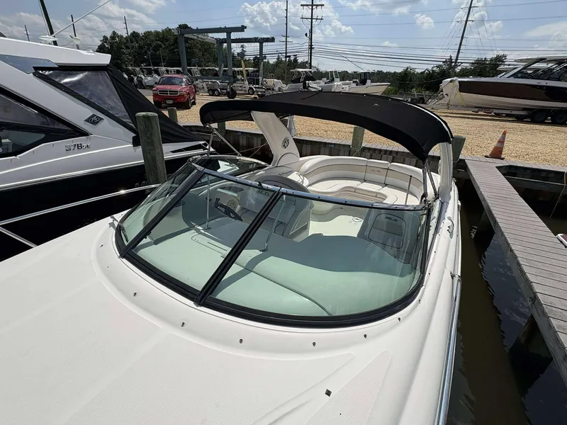 Slide: The Image of 2008 Sea Ray 290 SLX boat docked, featuring sleek design and spacious seating. - 4