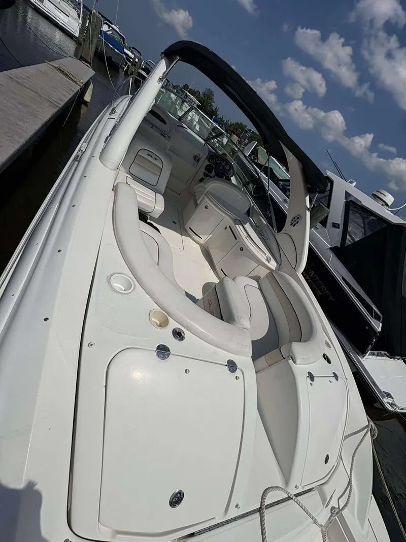 Slide: The Image of 2008 Sea Ray 290 SLX boat docked, featuring spacious seating and sleek design. - 5