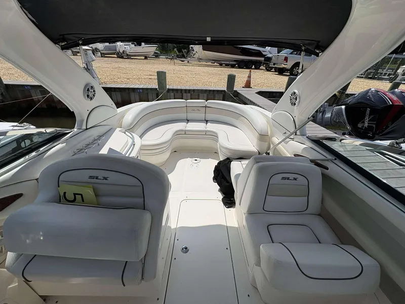 Slide: The Image of 2008 Sea Ray 290 SLX boat interior with white seating and open deck. - 6