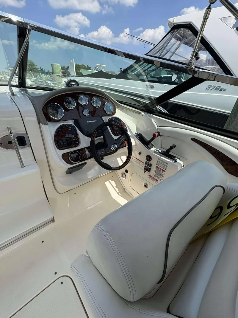 Slide: The Image of 2008 Sea Ray 290 SLX boat cockpit with steering wheel and control panel. - 7