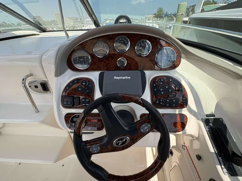 Slide: The Image of 2008 Sea Ray 290 SLX boat dashboard with steering wheel and control panel. - 8
