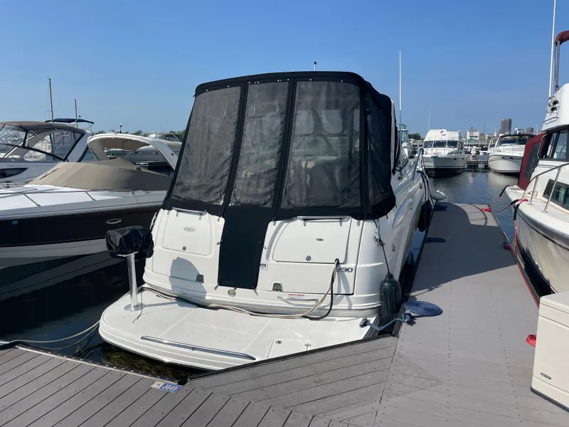 Slide: The Image of 2007 Chaparral 330 Signature boat docked at marina with black canvas cover. - 10