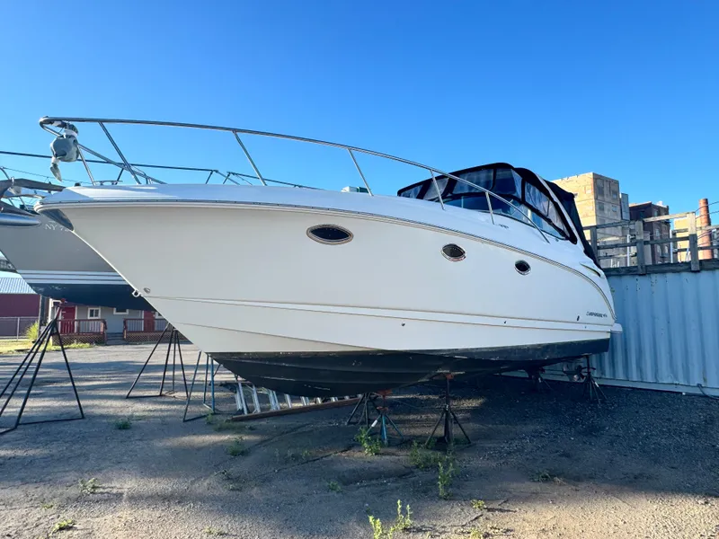 Slide: The Image of 2007 Chaparral 330 Signature boat on stands, clear sky background. - 3