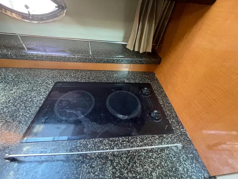 Slide: The Image of 2007 Chaparral 330 Signature boat kitchen with black electric stovetop. - 30