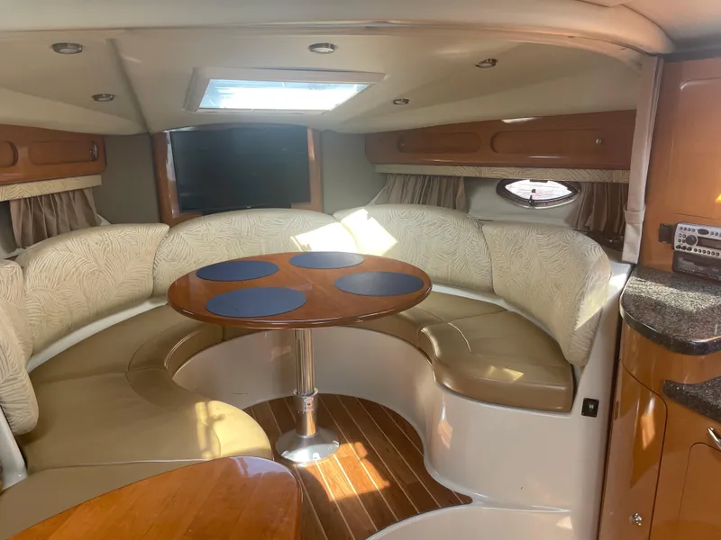 Slide: The Image of 2007 Chaparral 330 Signature boat interior with curved seating and dining table. - 34