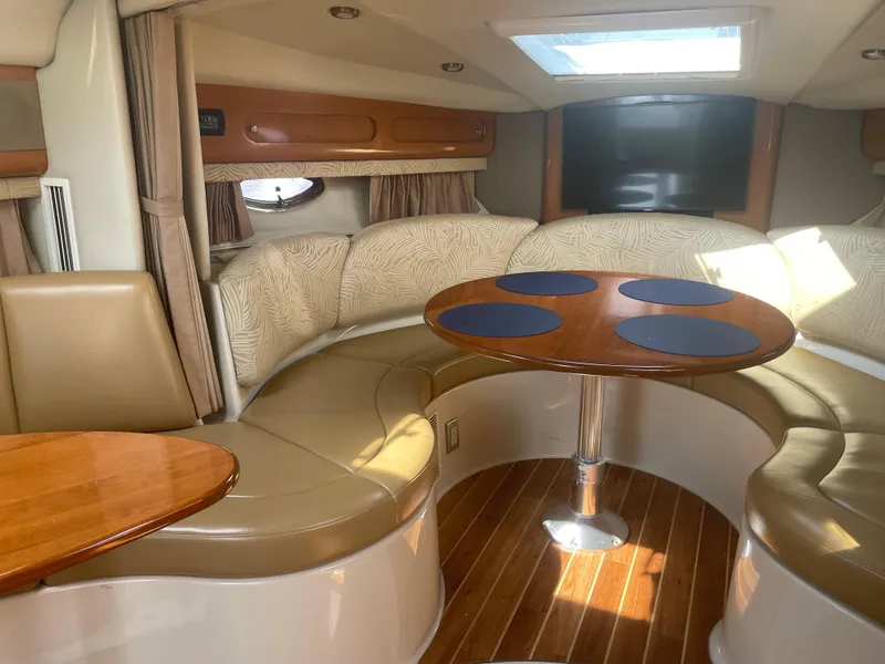 Slide: The Image of Interior of 2007 Chaparral 330 Signature boat with curved seating and wooden table. - 35