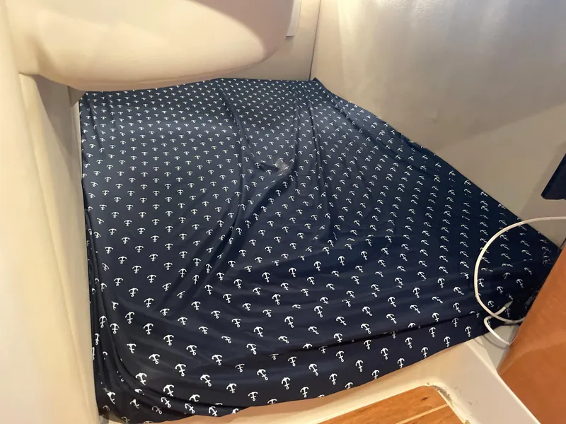 Slide: The Image of 2007 Chaparral 330 Signature cabin bed with anchor-patterned bedding. - 42