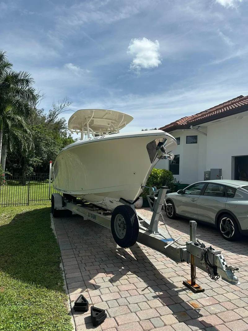 Slide: The Image of 2018 Sailfish 270 CC boat on trailer in residential driveway. - 1