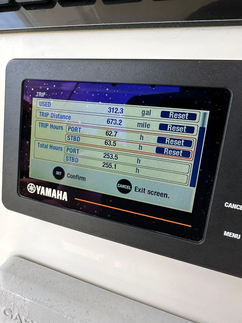 Slide: The Image of 2018 Sailfish 270 CC boat interior with console and American flag. - 17