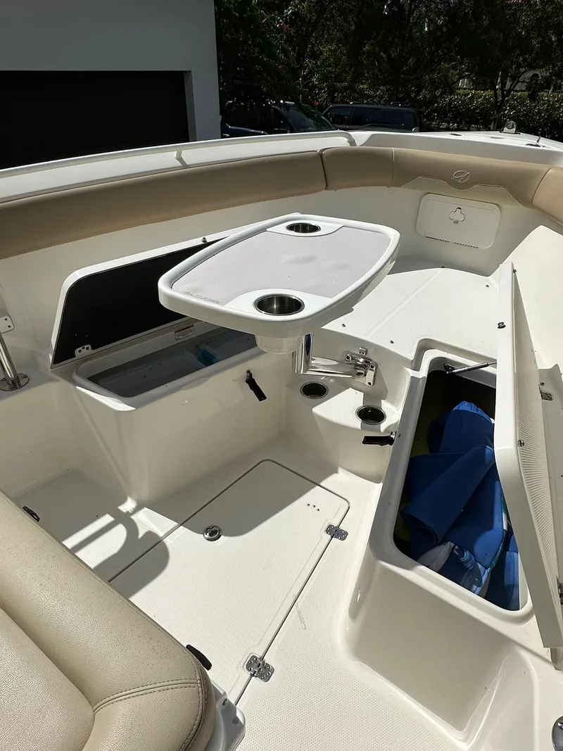 Slide: The Image of 2018 Sailfish 270 CC boat dashboard with Garmin displays and steering wheel. - 22