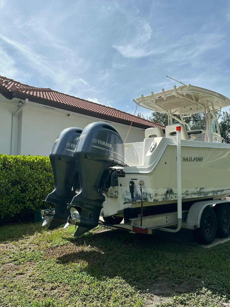 Slide: The Image of 2018 Sailfish 270 CC boat on trailer, side view, outdoors. - 4