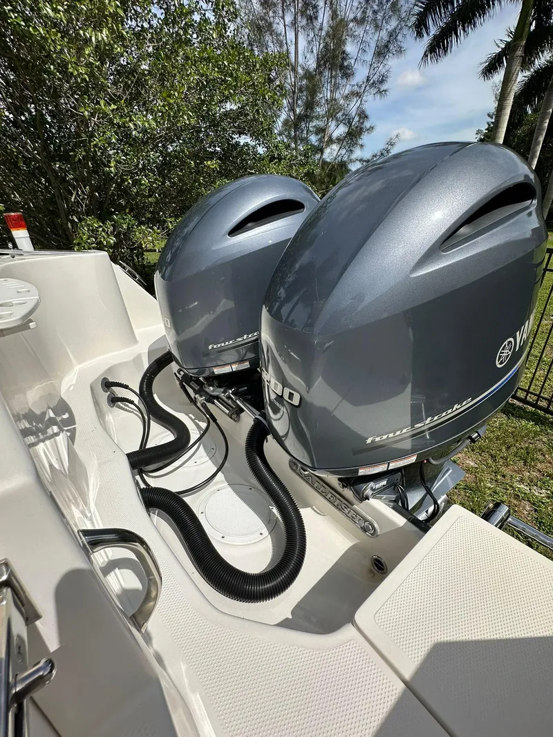 Slide: The Image of 2018 Sailfish 270 CC boat on trailer, featuring dual outboard motors. - 6