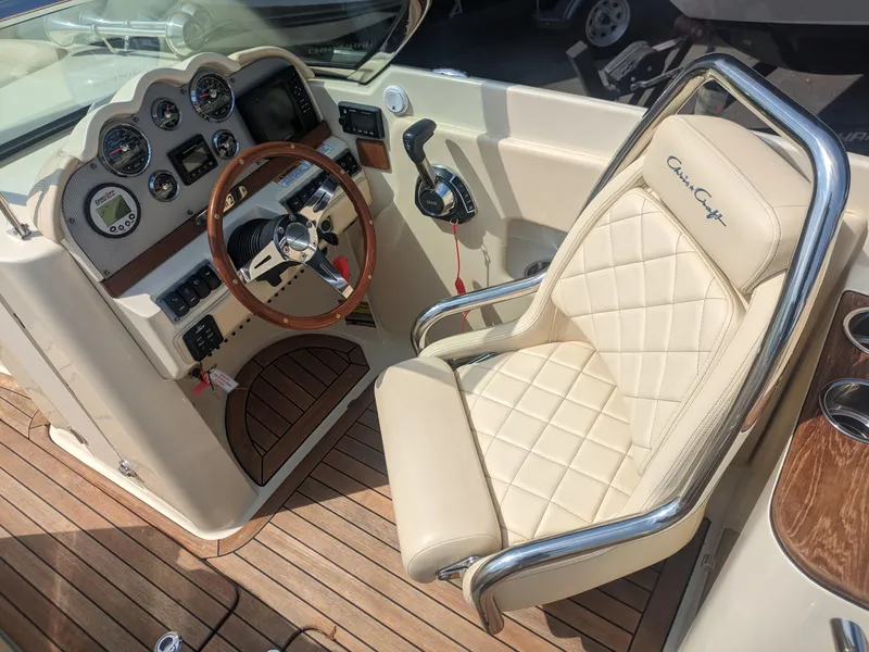 Slide: The Image of 2018 Chris-Craft Launch 27 cockpit with beige leather seat and wooden steering wheel. - 10