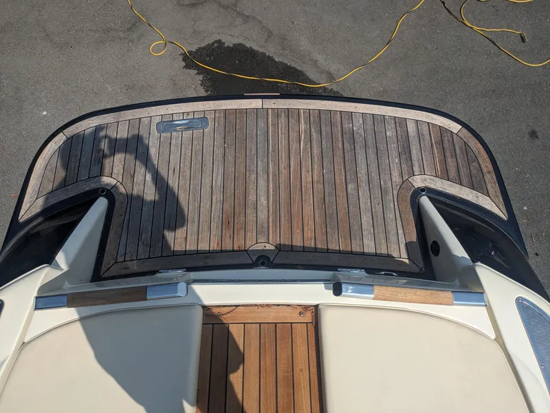 Slide: The Image of 2018 Chris-Craft Launch 27 boat with wooden deck, viewed from above. - 18