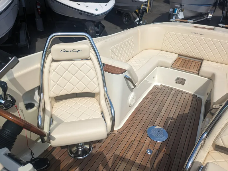 Slide: The Image of 2018 Chris-Craft Launch 27 boat interior with cream seating and wooden flooring. - 9