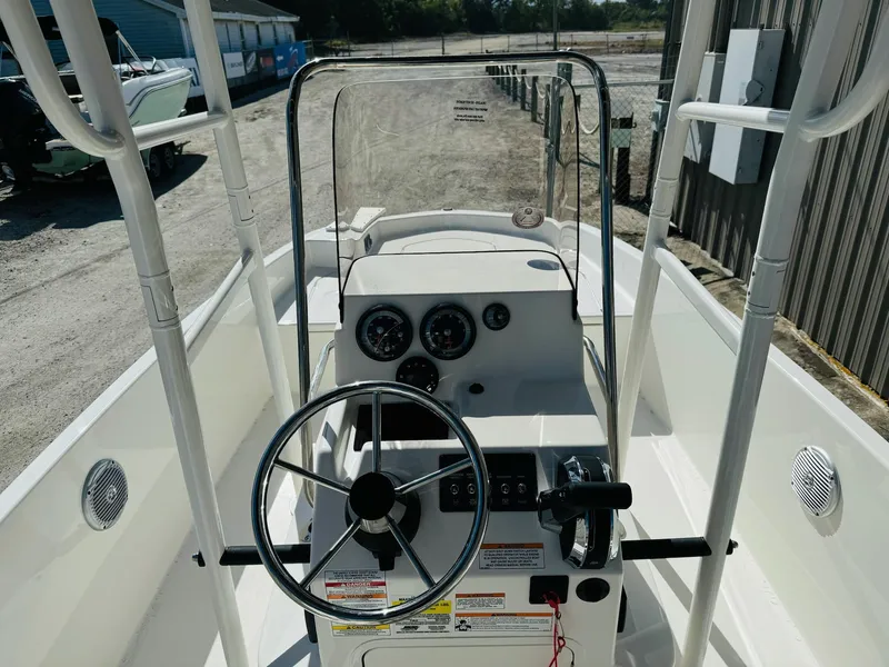 Slide: The Image of 2025 Bayliner Trophy T18 boat cockpit with steering wheel and control panel. - 11