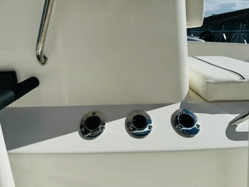 Slide: The Image of 2025 Bayliner Trophy T18 boat interior detail with chrome fittings and white seating. - 13
