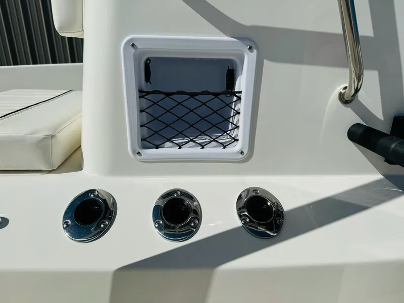 Slide: The Image of 2025 Bayliner Trophy T18 boat detail with storage net and chrome fittings. - 14