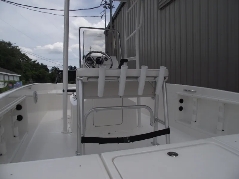 Slide: The Image of 2025 Bayliner Trophy T18 boat interior with steering console and rod holders. - 18