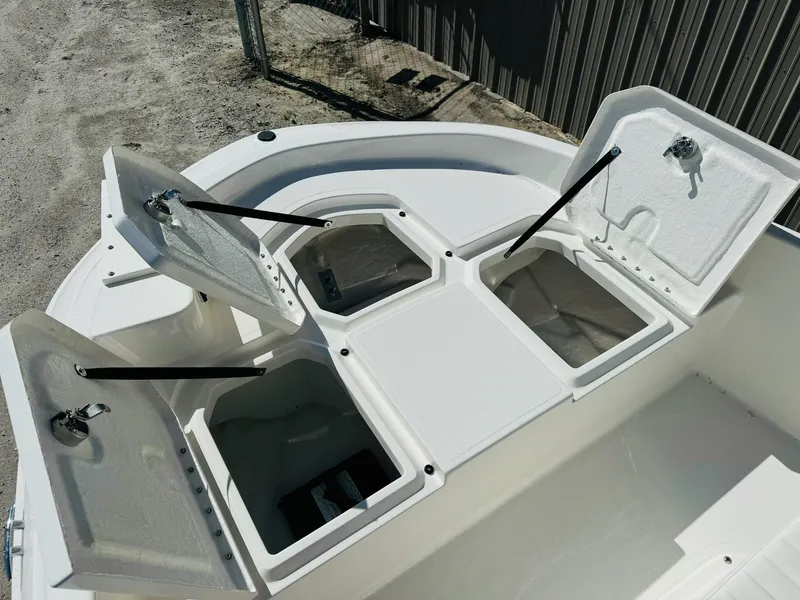 Slide: The Image of 2025 Bayliner Trophy T18 boat storage compartments open on deck. - 7