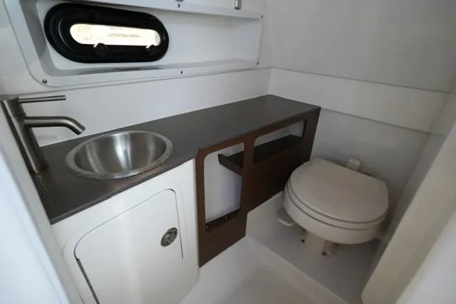 Slide: The Image of 2022 Sea Ray SDX 270 boat bathroom with sink and toilet. - 10