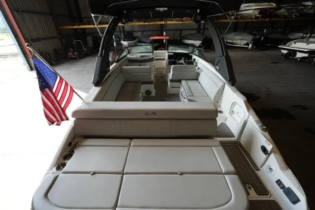 Slide: The Image of 2022 Sea Ray SDX 270 boat interior with American flag, docked in a warehouse. - 12