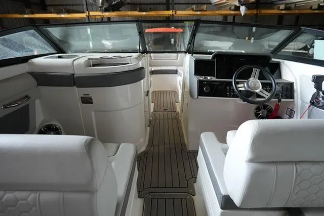 Slide: The Image of 2022 Sea Ray SDX 270 boat interior with modern dashboard and seating. - 8