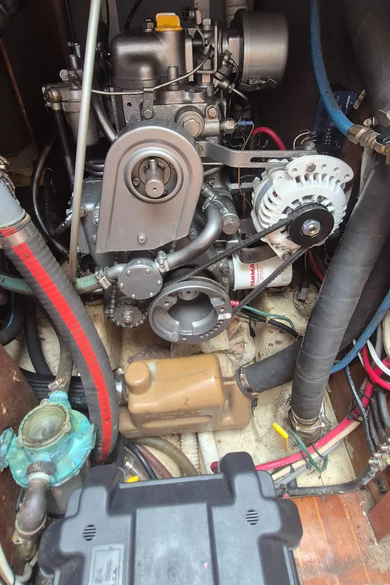 Slide: The Image of Engine compartment of a 1979 Bristol 35.5 sailboat, showcasing mechanical components and wiring. - 16