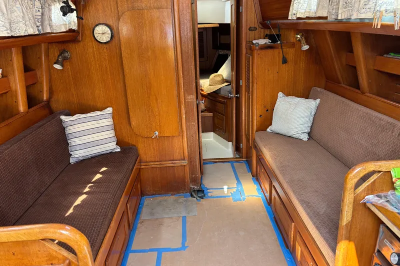 Slide: The Image of Interior of a 1979 Bristol 35.5 sailboat with wooden furnishings and cozy seating. - 2