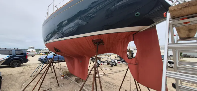 Slide: The Image of 1979 Bristol 35.5 sailboat on stands, showing hull and keel in a boatyard. - 21
