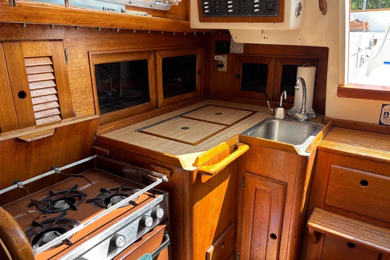 Slide: The Image of 1979 Bristol 35.5 yacht kitchen with wooden cabinetry, stove, and sink. - 6