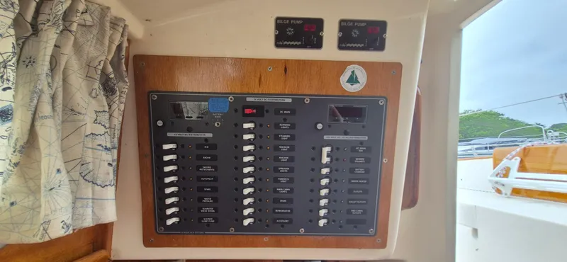 Slide: The Image of Electrical panel on a 1979 Bristol 35.5 sailboat, featuring switches and bilge pump indicators. - 9